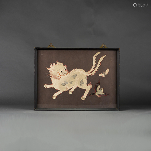 A FRAMED EMBROIDERY OF MYTHICAL BEAST