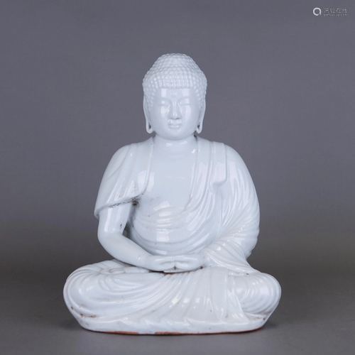 A WHITE-GLAZED SEATED FIGURE OF SHAKYAMUNI