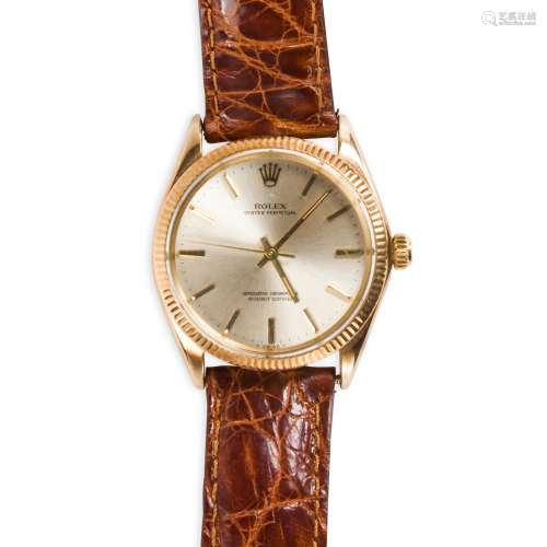 A fourteen karat gold and stainless steel wristwatch,