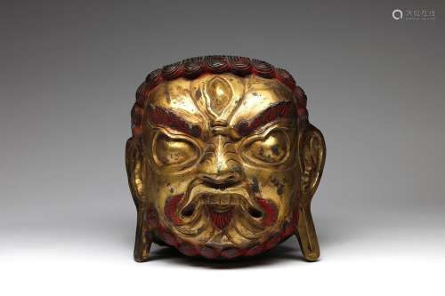 Arte Himalayana A large gilded copper embossed head of Mahak...