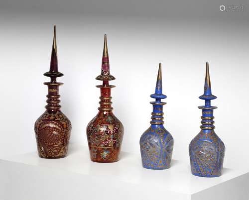 Arte Islamica A group of four gilded enamelled glass bottles...