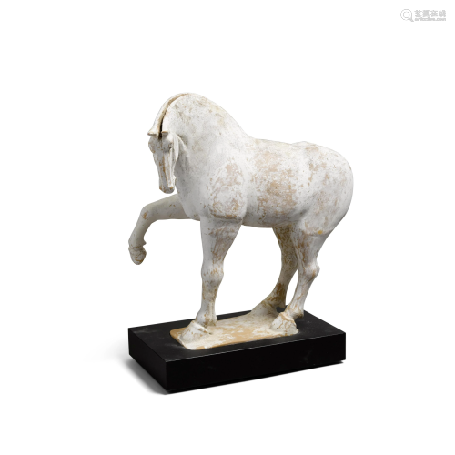 An unglazed pottery figure of a prancing horse Tang