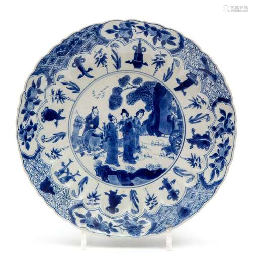 A blue and white plate with figures