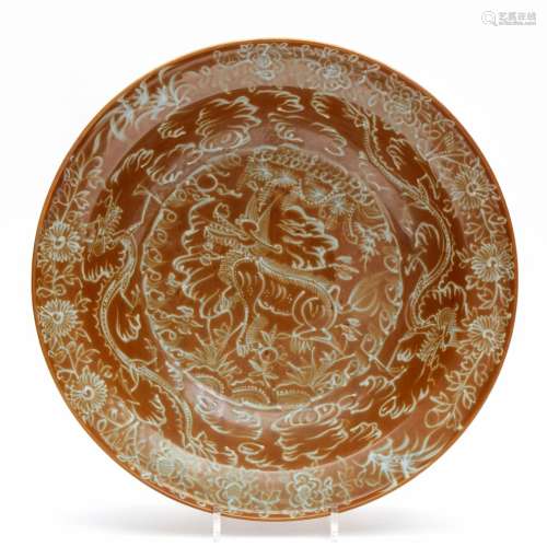 A large brown glaze Swatow dish with slip decoration