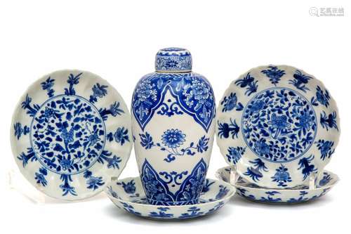 A blue and white lidded vase and four plates