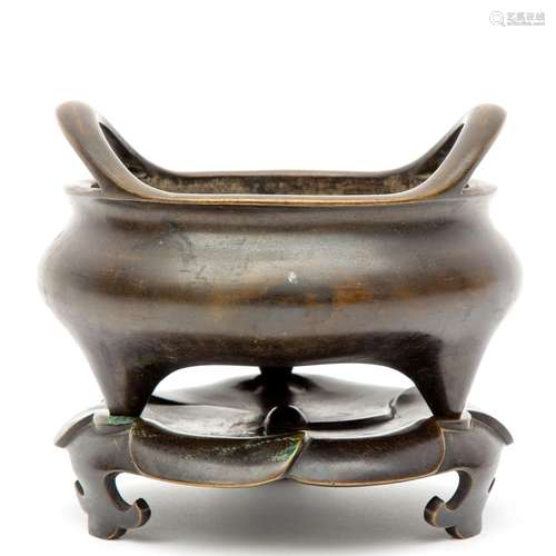 A Chinese bronze tripod censer on base