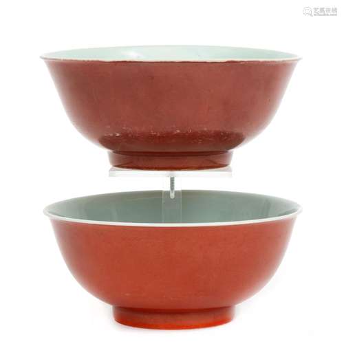 A pair of coral red bowls