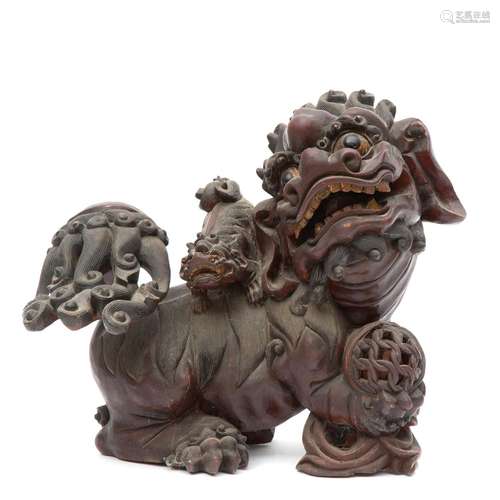 A large wood carved foo dog figure