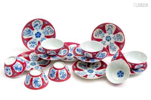 Eight ruby ground cups and saucers with blue enamel