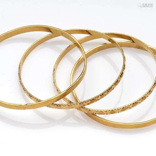 Four 20k gold bangles