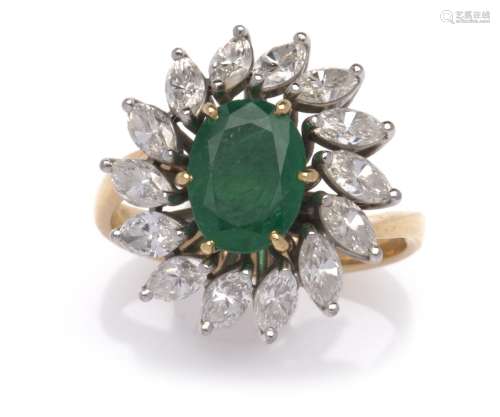 An 18k gold emerald and diamond ring