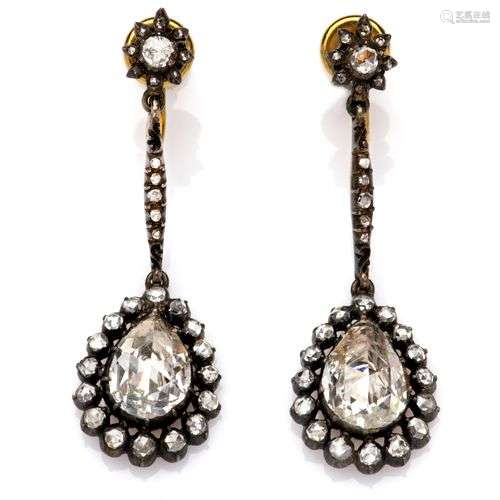 A pair of 14k gold and silver diamond earrings