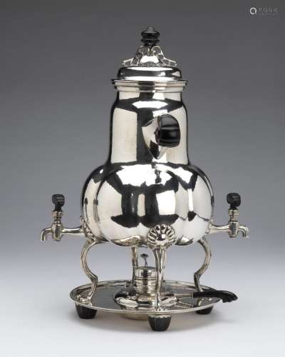 A large silver coffee urn with two taps
