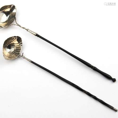Two Dutch silver punch ladles, with whale bone and wooden ha...