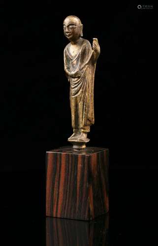 A GILT LACQUERED BRONZE FIGURE OF A STANDING MONK China, Mos...
