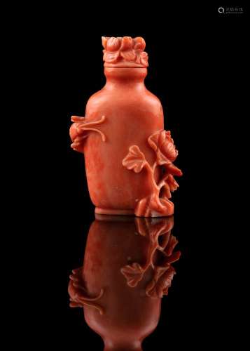 *A CARVED RED CORAL SNUFF BOTTLE WITH MATCHING STOPPER China...
