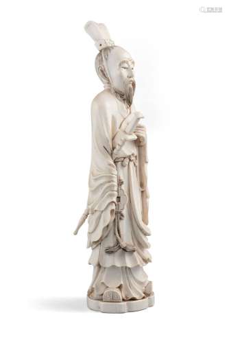 *A CARVED IVORY FIGURE OF A STANDING WARRIOR WITH A SWORD, P...