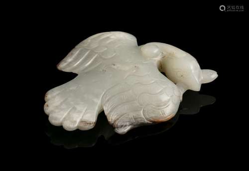 A MOTTLED JADE CARVING OF A FLYING PHOENIX China Depicted as...
