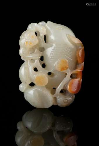 A WHITE AND RUSSET JADE GROUP CARVING OF A GOLDFISH OF ABUND...