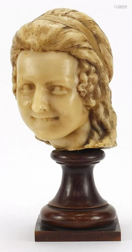 Wax bust of a female raised on turned mahogany pedestal