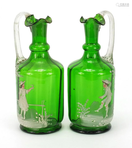 Pair of Victorian Mary Gregory green glass claret jugs,