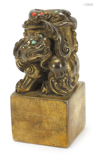 Chinese patinated bronze dog of Foo seal set with