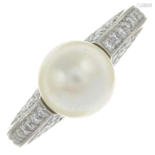 A pearl single-stone ring, with pavé-set diamond shoulders.