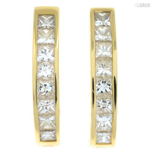 A pair of square-shape diamond hoop earrings.Estimated total...