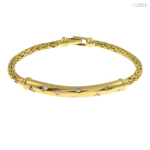 A bangle, with brilliant-cut diamond highlights.Estimated to...