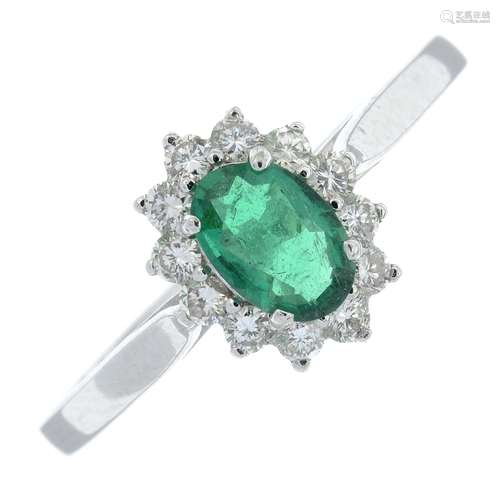 An emerald and brilliant-cut diamond cluster ring.Estimated ...