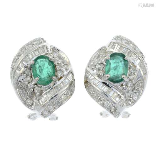 A pair of emerald and vari-cut diamond scrolling cluster ear...