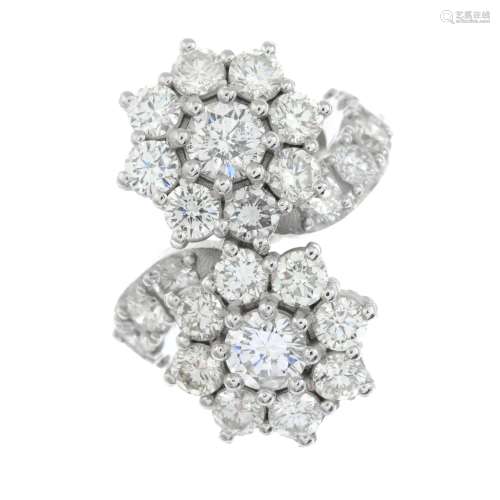 A brilliant-cut diamond cluster crossover ring.Estimated tot...