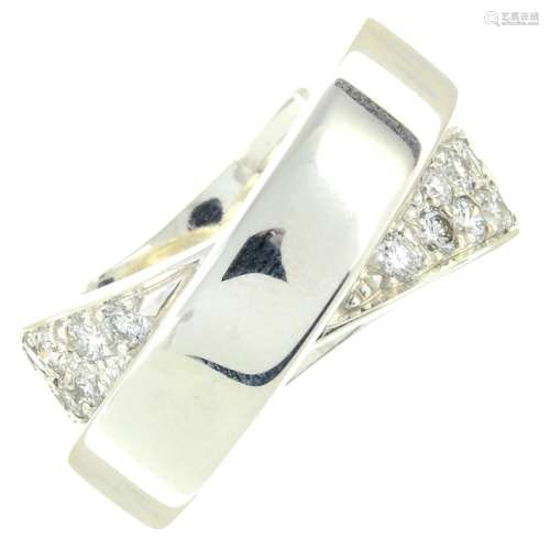 A pave-set diamond crossover dress ring.Estimated total diam...