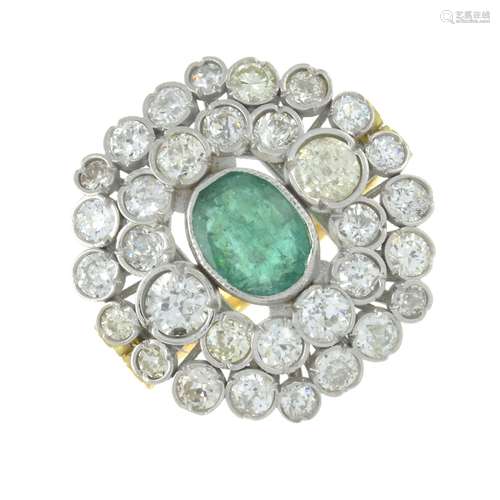 An emerald and diamond cluster ring.Emerald calculated weigh...