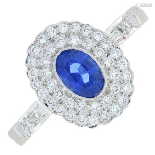 A sapphire and brilliant-cut diamond cluster ring.Sapphire c...