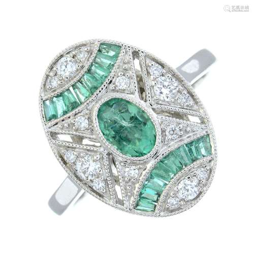 An 18ct gold emerald and pave-set diamond dress ring.Emerald...