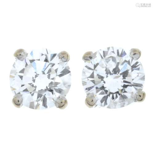A pair of brilliant-cut diamond single-stone stud earrings.E...