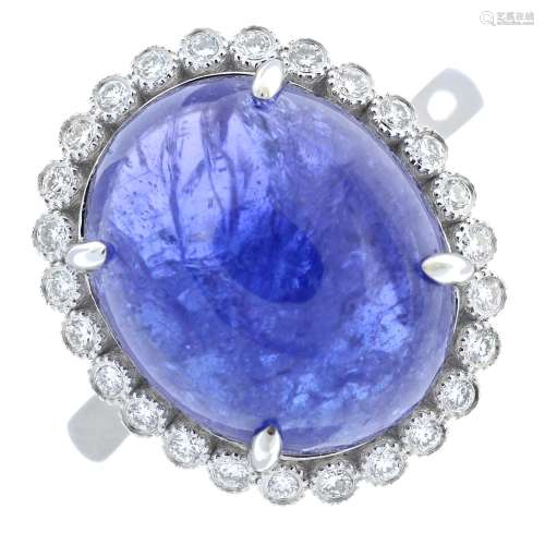 A tanzanite cabochon and brilliant-cut diamond cluster ring....