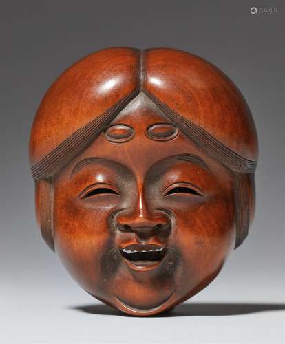 Masque netsuke. Buis et ivoire. Milieu du XIXe siècle. Sur l...