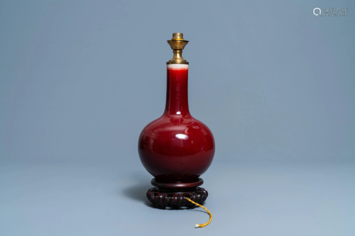 A Chinese monochrome sang de boeuf lamp-mounted bottle