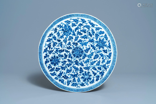 A large Chinese round blue and white plaque with floral