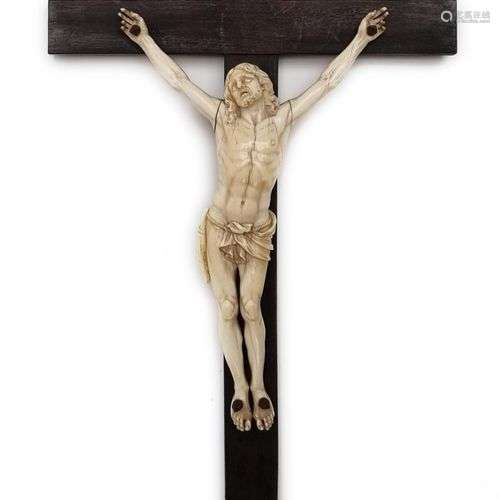 A carved ivory figure of Christ on the Cross