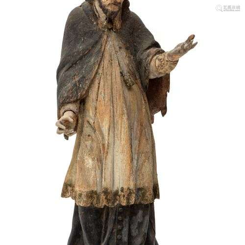 A carved and polychrome painted figure of St. John of Nepomu...