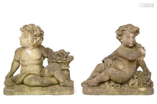 A pair of composite stone sitting putti