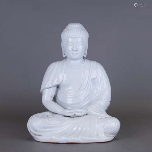 A WHITE-GLAZED SEATED FIGURE OF SHAKYAMUNI