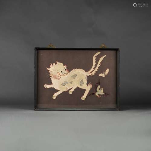 A FRAMED EMBROIDERY OF MYTHICAL BEAST