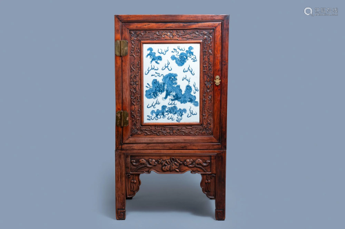 A Chinese hongmu cupboard with a blue and white