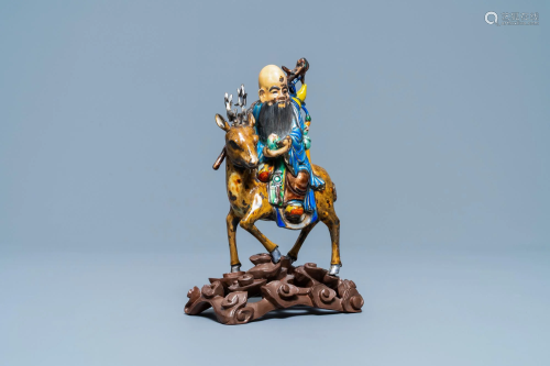 A Chinese enamelled silver figure of Shou Lao on a