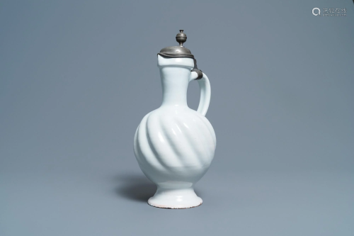 A large gadrooned white Dutch Delftware jug with pewter