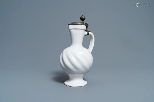 A gadrooned white Dutch Delftware jug with pewter